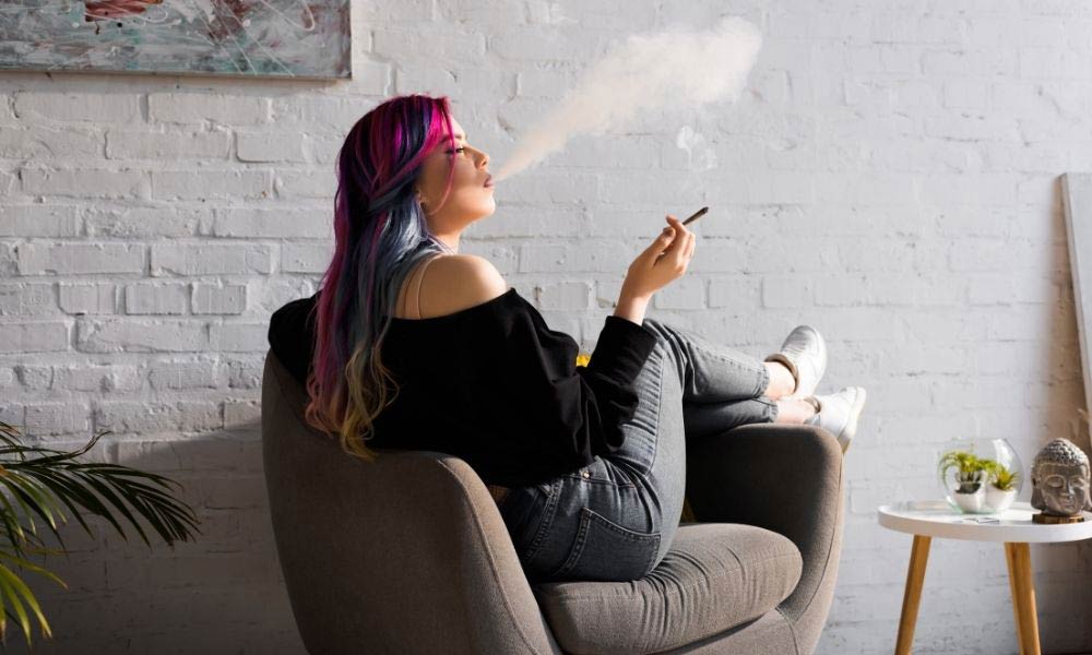 woman smoking joint in chair